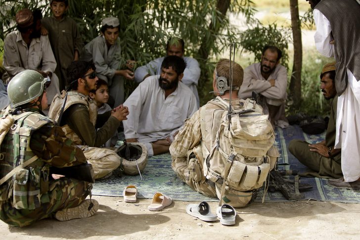 British army Sgt. Scott Roxborough, with Headquarters Company, 2nd Battalion, Mercian Regiment, talks with Afghan men during a civil affairs patrol in the Nawa district of the Helmand province of Afghanistan Aug. 4, 2009. Roxborough is assigned to the 4th Operational Mentor Liaison Team, which comprises Afghan National Army soldiers, British soldiers and U.S. Marines with 1st Battalion 5th Marine Regiment. (DoD photo by Lance Cpl. James Purschwitz, U.S. Marine Corps/Released)